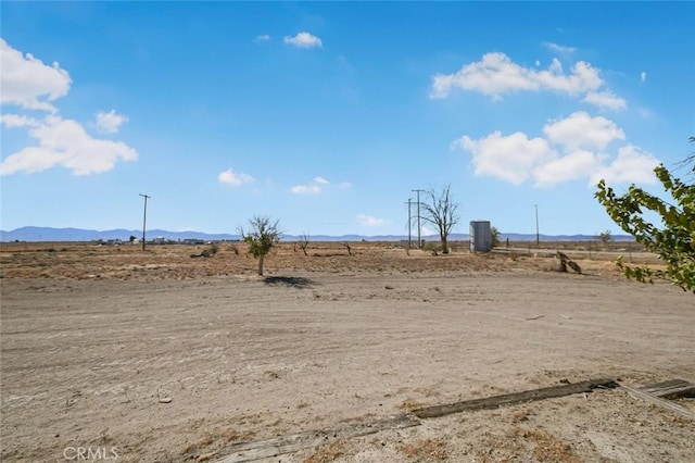 view of yard featuring a rural view and a mountain view