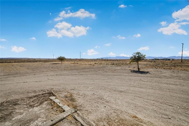 view of yard featuring a rural view and a mountain view