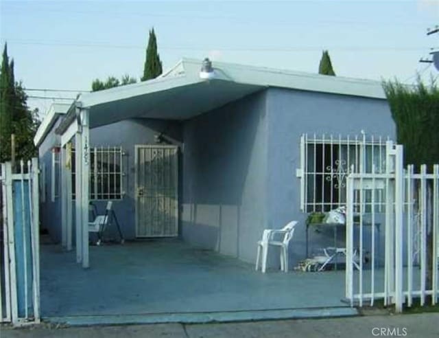 view of outbuilding featuring fence and a gate