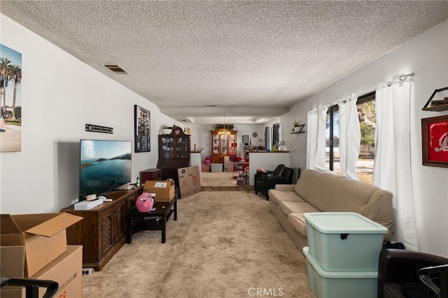 living room featuring a textured ceiling, visible vents, and light colored carpet