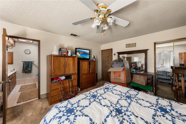 bedroom featuring a textured ceiling, ceiling fan, carpet, and visible vents