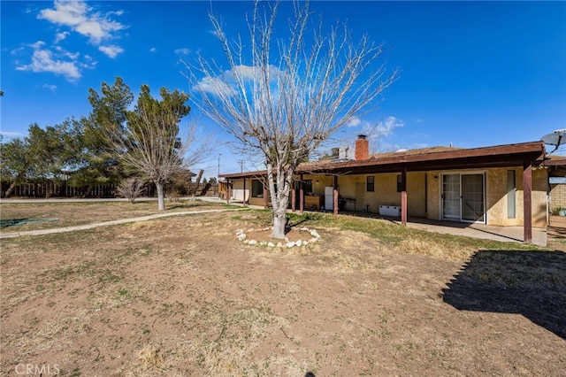 back of property with a chimney