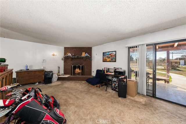 living area with a textured ceiling, carpet floors, and a brick fireplace