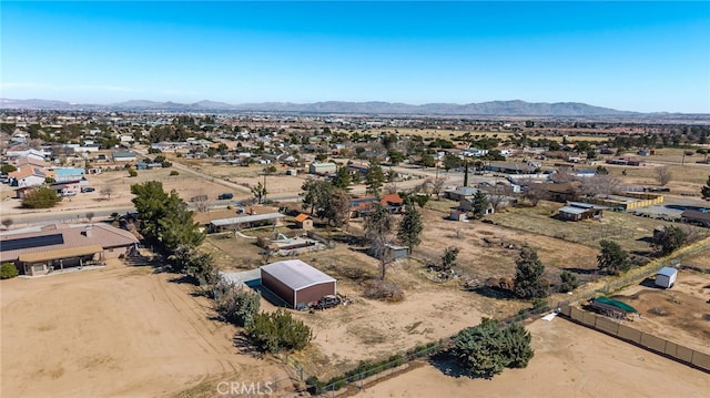 drone / aerial view featuring a desert view and a mountain view