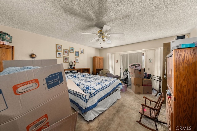 carpeted bedroom featuring a textured ceiling and ceiling fan