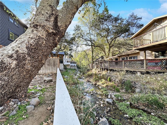 view of yard with a deck and fence