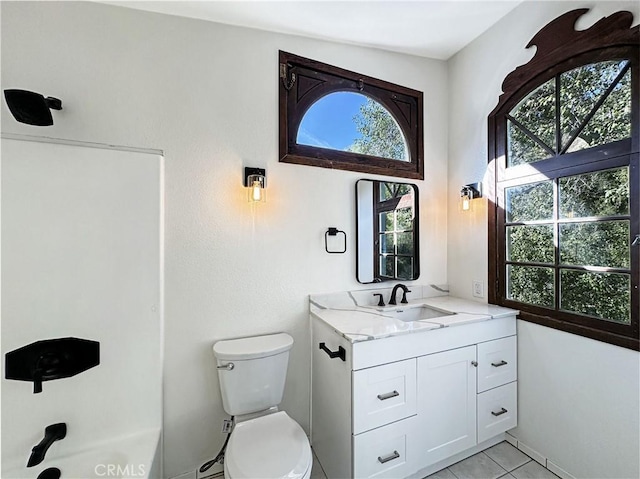 bathroom featuring tile patterned flooring, vanity, and toilet