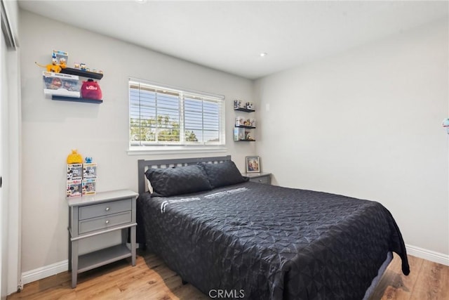 bedroom with wood finished floors and baseboards