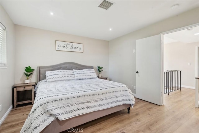 bedroom with light wood-style flooring, recessed lighting, visible vents, and baseboards