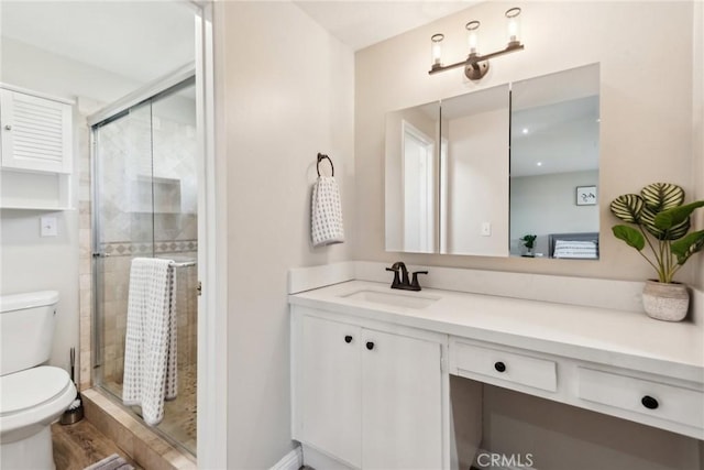 full bath featuring toilet, a shower stall, and vanity