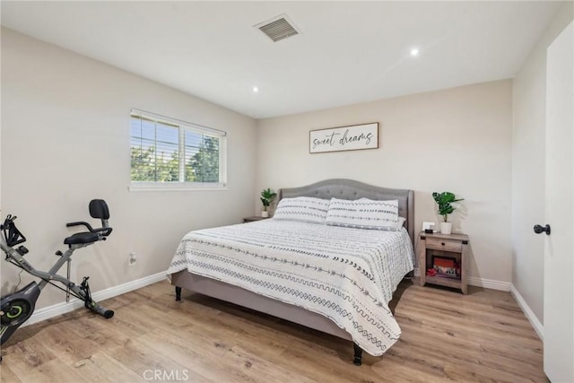 bedroom with recessed lighting, wood finished floors, visible vents, and baseboards