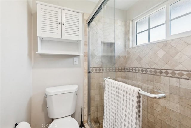 full bathroom with a stall shower, radiator, and toilet