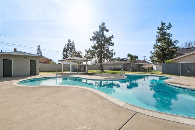 view of pool featuring a fenced in pool, fence, a patio, and a gazebo