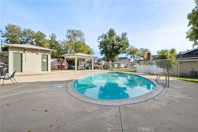 view of swimming pool with a patio area, fence, and a fenced in pool