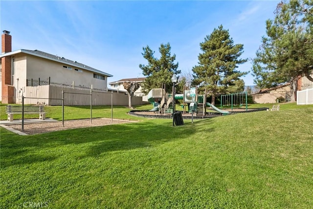 view of yard with fence and playground community