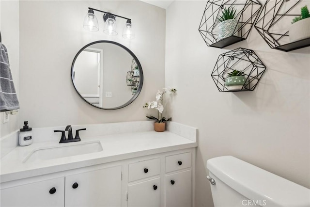 bathroom featuring toilet and vanity