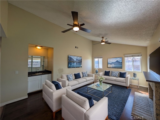 living room featuring visible vents, dark wood-type flooring, vaulted ceiling, a textured ceiling, and baseboards