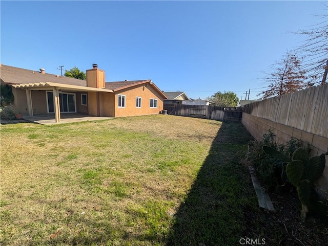 view of yard with a patio area and a fenced backyard