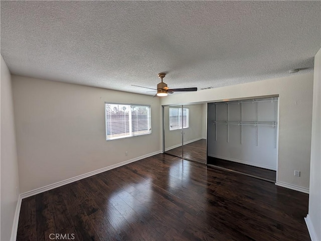 unfurnished bedroom featuring a ceiling fan, a closet, baseboards, and wood finished floors