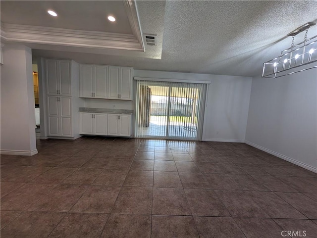 spare room with recessed lighting, visible vents, ornamental molding, a textured ceiling, and baseboards