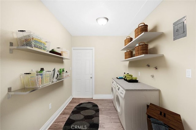 kitchen featuring baseboards, open shelves, light wood-style flooring, and washer and dryer