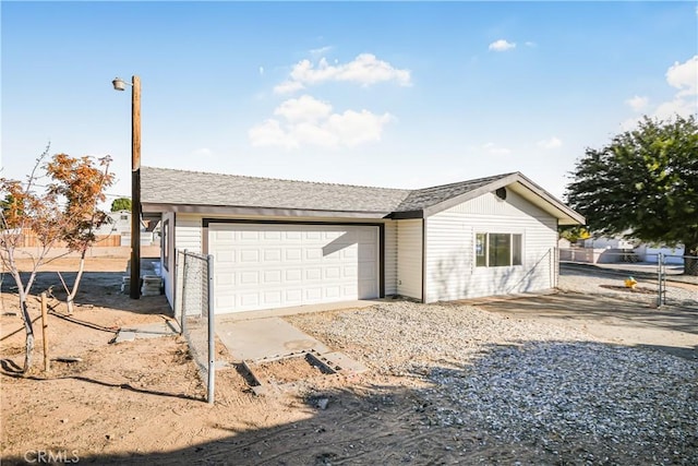 exterior space with an attached garage and fence