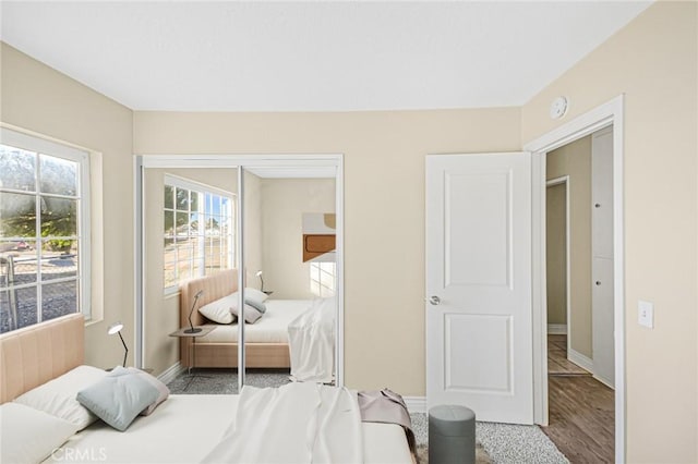 bedroom with baseboards and a closet