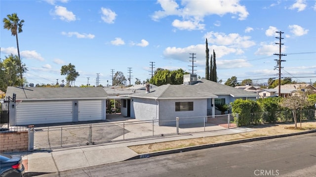 ranch-style house with a fenced front yard, stucco siding, driveway, and an attached garage