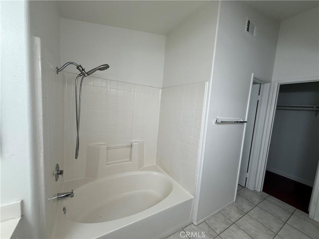 bathroom with shower / bath combination, tile patterned flooring, and visible vents