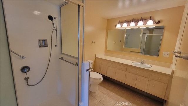 bathroom with toilet, a stall shower, tile patterned floors, and vanity