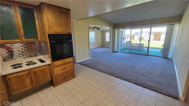 kitchen with light carpet, black oven, white electric stovetop, and brown cabinetry