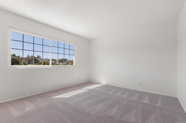 empty room with carpet and baseboards