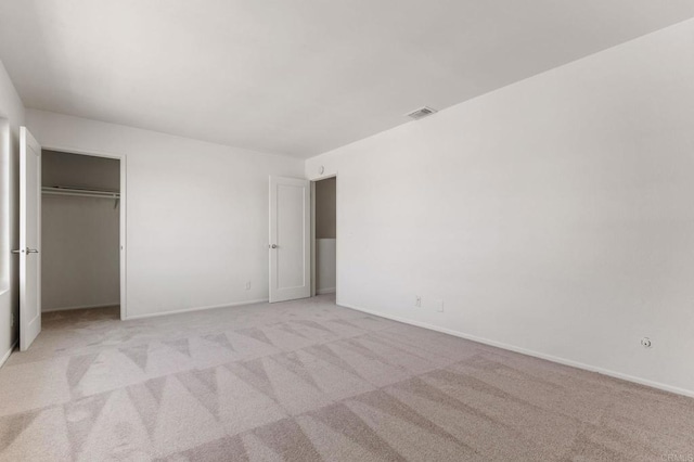 unfurnished bedroom with visible vents, baseboards, and light colored carpet