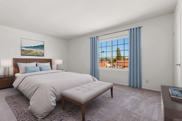 carpeted bedroom featuring baseboards