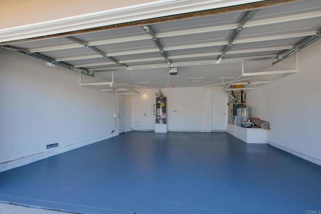 garage featuring secured water heater and a garage door opener