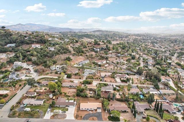 drone / aerial view featuring a residential view and a mountain view