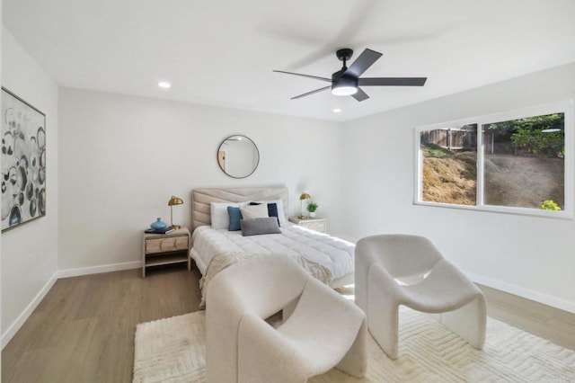 bedroom with ceiling fan, recessed lighting, wood finished floors, and baseboards