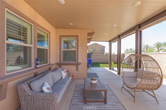 view of patio featuring fence and an outdoor living space