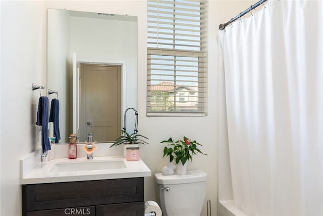 bathroom with shower / tub combo, vanity, and toilet