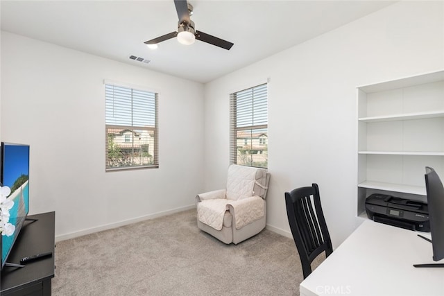 office with carpet floors, ceiling fan, visible vents, and baseboards