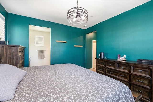 bedroom with a notable chandelier