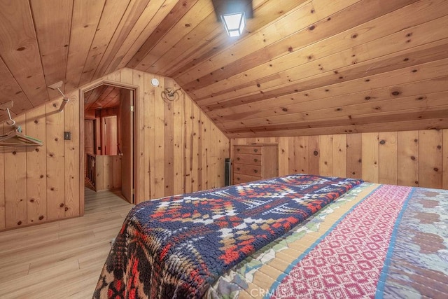 bedroom featuring lofted ceiling, wooden ceiling, wood walls, and wood finished floors