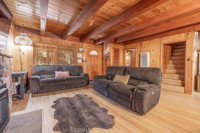 living area featuring wooden ceiling, stairs, wooden walls, and wood finished floors