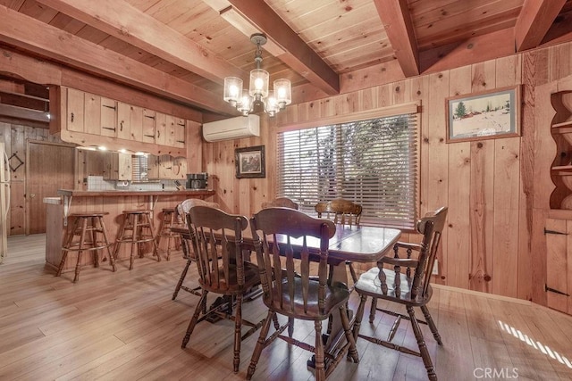 dining space with wooden ceiling, light wood-style flooring, wooden walls, beam ceiling, and a wall mounted air conditioner