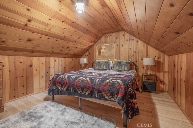 bedroom with vaulted ceiling, wooden ceiling, wood finished floors, and wooden walls