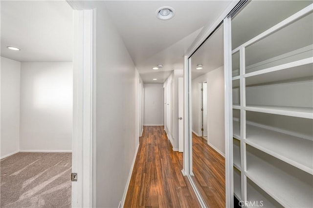 hallway with recessed lighting, baseboards, and wood finished floors