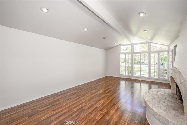 unfurnished living room featuring vaulted ceiling with beams, dark wood-style flooring, and a fireplace