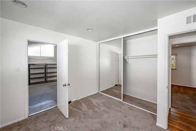 unfurnished bedroom with carpet floors, recessed lighting, visible vents, and baseboards