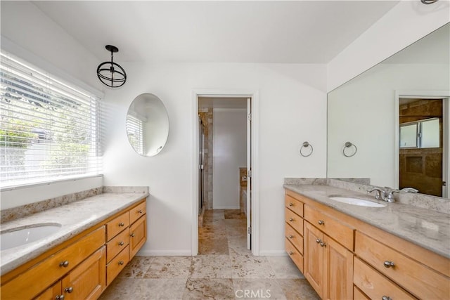 bathroom with two vanities, a sink, and baseboards