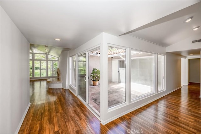 unfurnished sunroom with lofted ceiling and visible vents